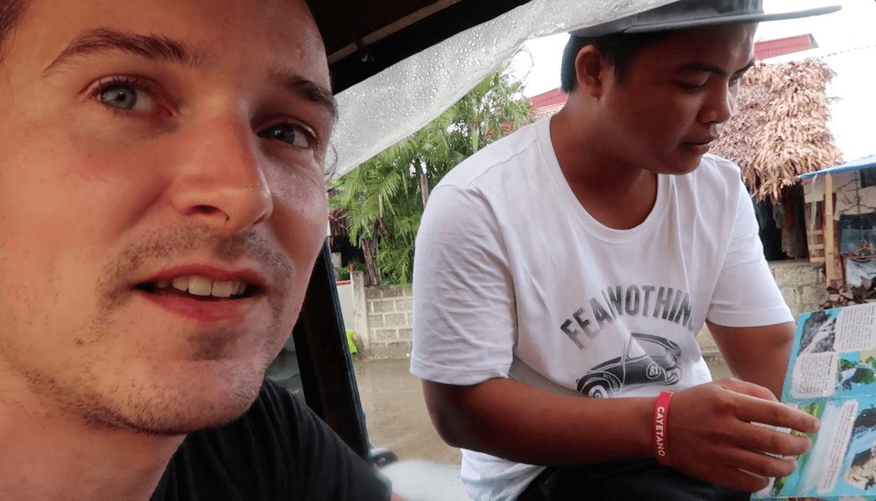 Lenny through paradise sitting it tricycle with filipino driver looking at map in catanduanes island the philippines